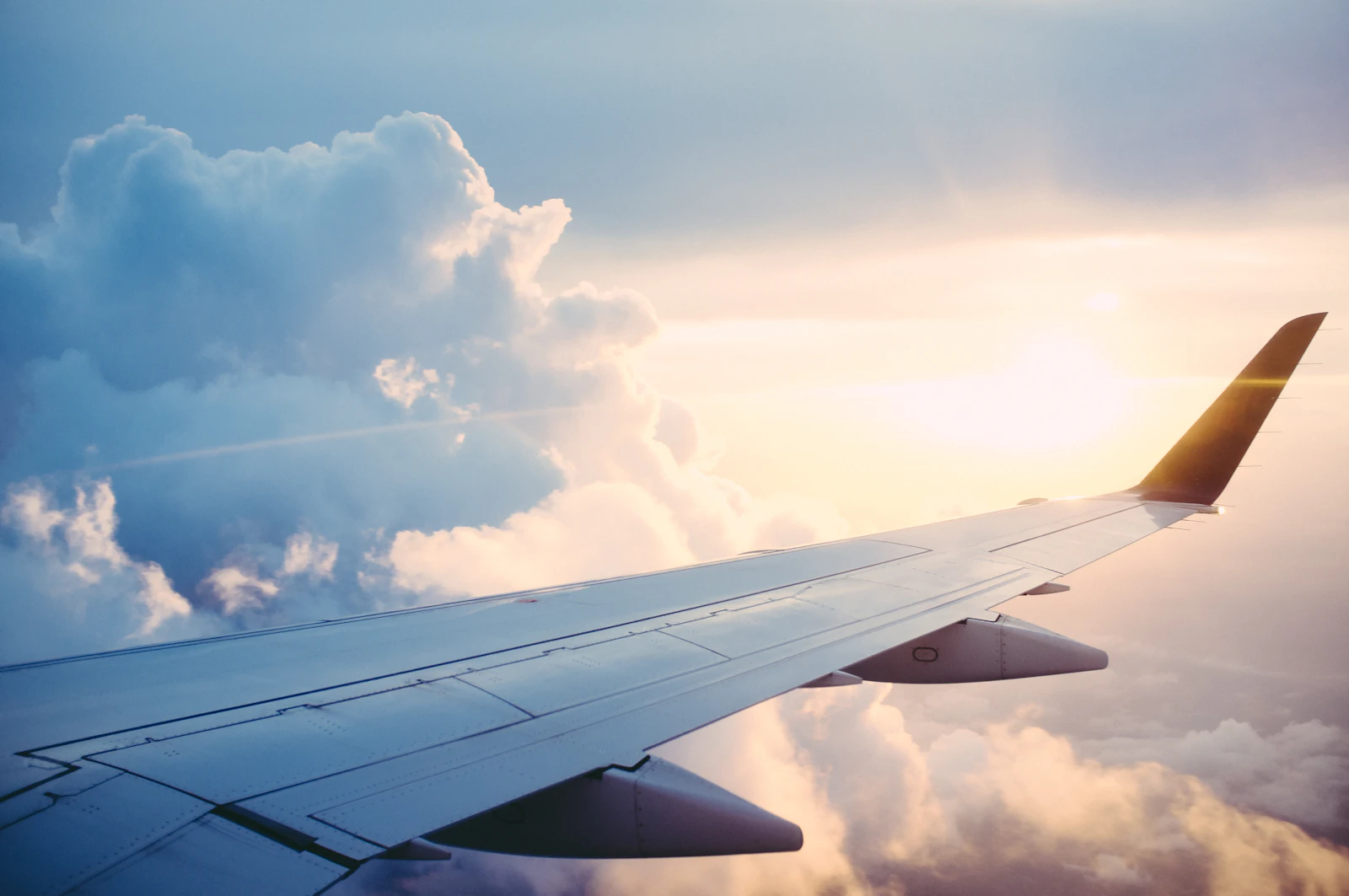 Commercial aircraft above the clouds at sunset